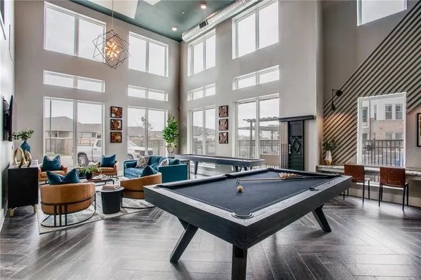a room with furniture pool table and windows