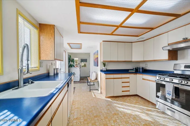 a bedroom with a large bed a flat tv screen and dresser