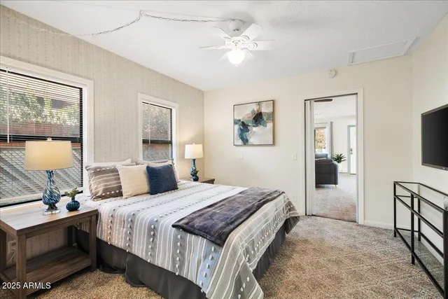 a bedroom with a bed and a flat screen tv