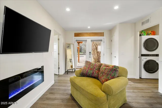 a view of a patio with table and chairs with wooden floor and fence