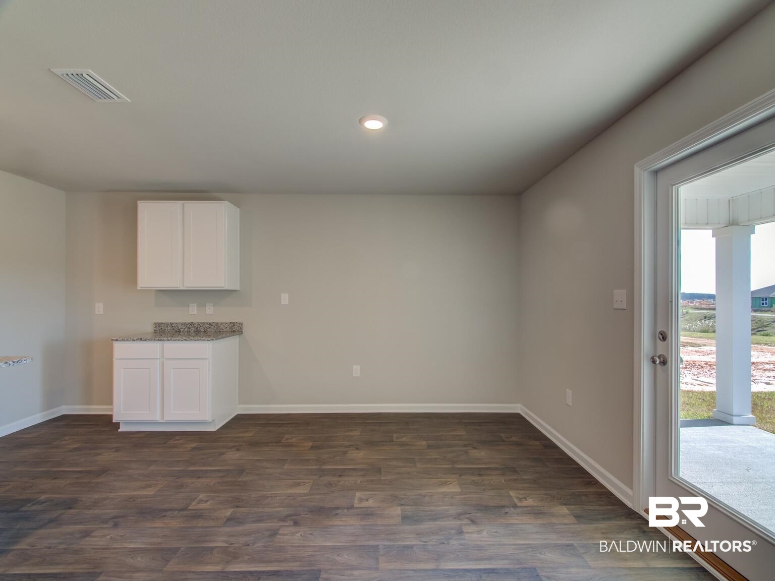 23953 Citation Loop Daphne, AL 36526 - Photo 9 of 49 Kitchen with white cabinets, dark wood finished floors, light stone countertops, and recessed lighting