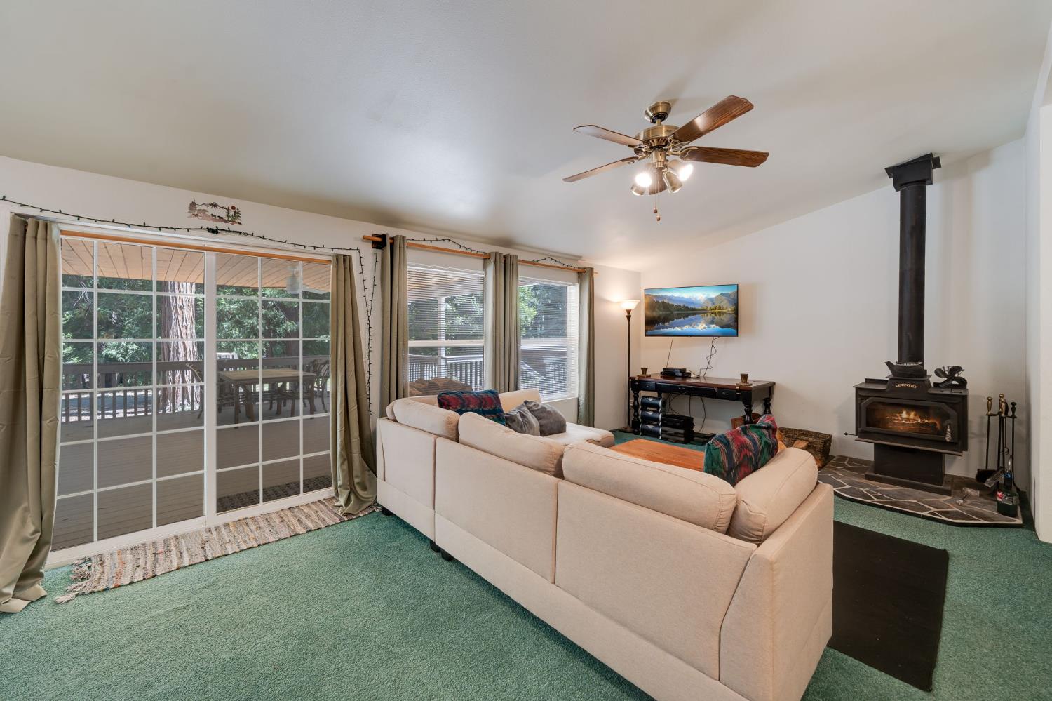 28722 Wood Road Pioneer, CA 95666 - Photo 11 of 39 a living room with furniture a fireplace and a flat screen tv