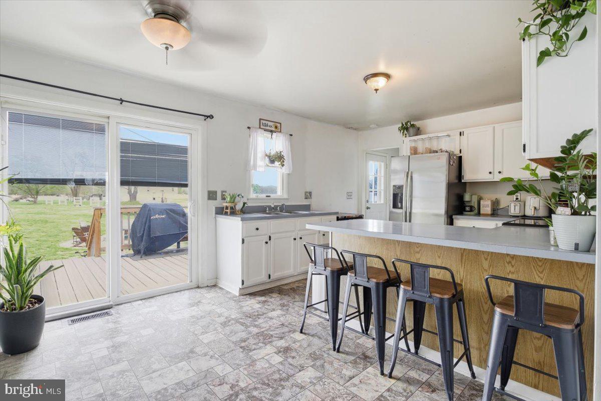 15421 Oakland Road Goldsboro, MD 21636 - Photo 5 of 20 a kitchen with stainless steel appliances a sink and a refrigerator