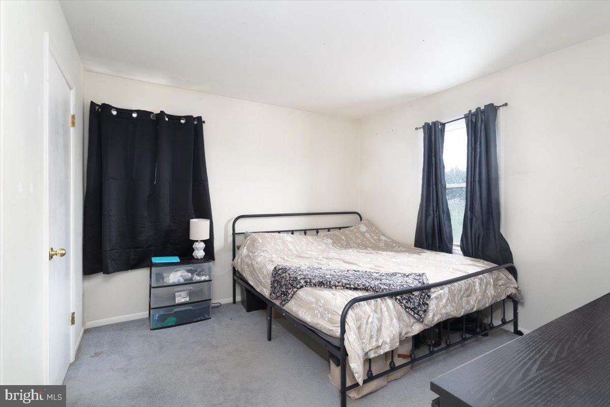 15421 Oakland Road Goldsboro, MD 21636 - Photo 9 of 20 a bedroom with a bed and a night stand