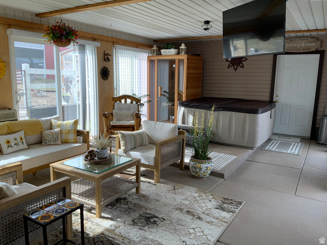 1061 Copper Street Stockton, UT 84071 - Photo 22 of 43 Enclosed patio space featuring a built-in hot tub, concrete flooring, and multiple sliding glass doors