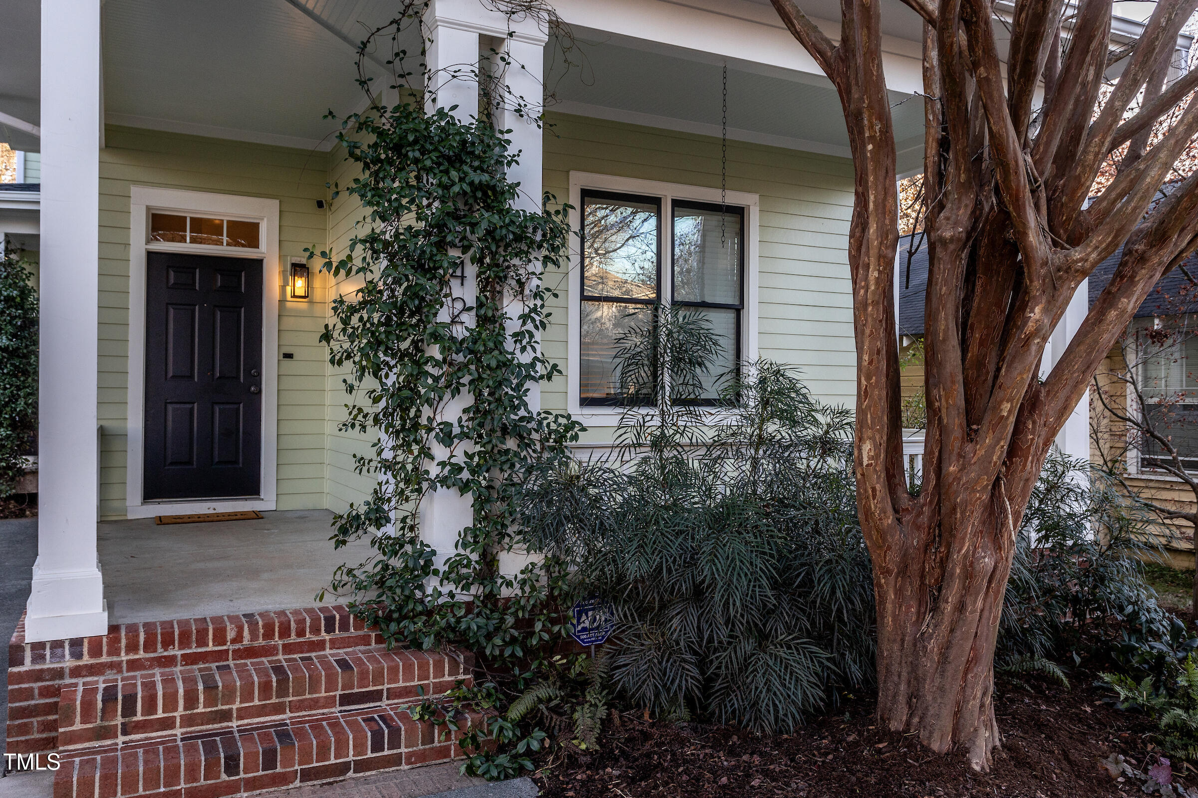 542 East Martin Street Raleigh, NC 27601 - Photo 3 of 45 a view of a house with a small yard and potted plants
