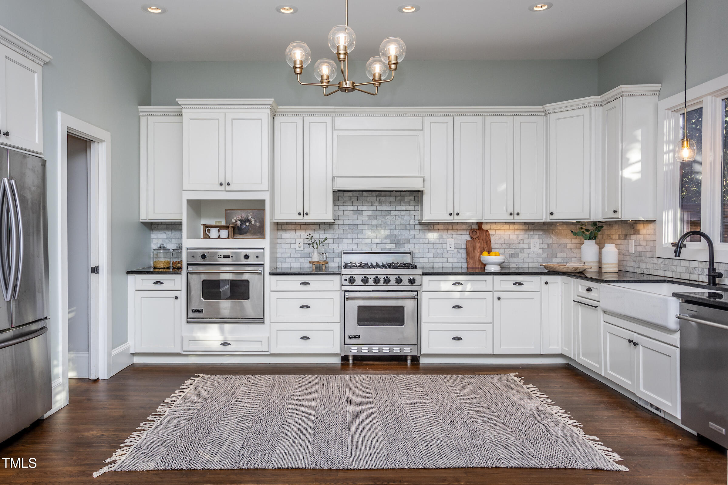 542 East Martin Street Raleigh, NC 27601 - Photo 6 of 45 a kitchen with stainless steel appliances granite countertop a stove a sink and a refrigerator