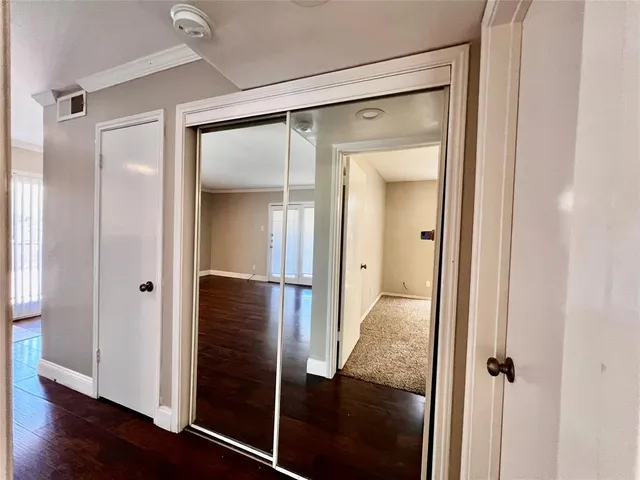 an empty room with a ceiling fan and window