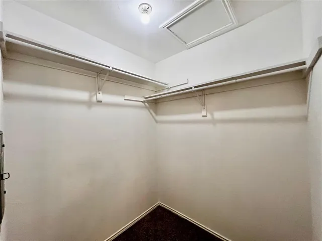 a bathroom with a granite countertop sink toilet and mirror