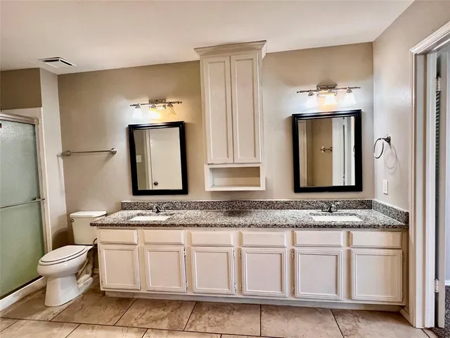 a spacious bathroom with a granite countertop tub sink and mirror