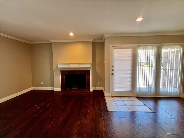 wooden floor in an empty room with a fireplace