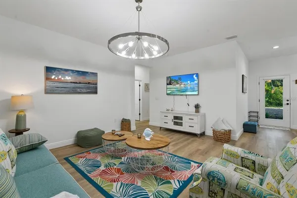 a living room with furniture and wooden floor