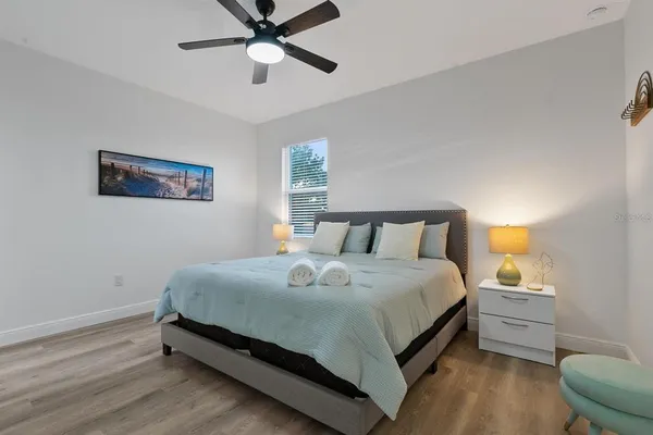 a bedroom with a bed and a chandelier