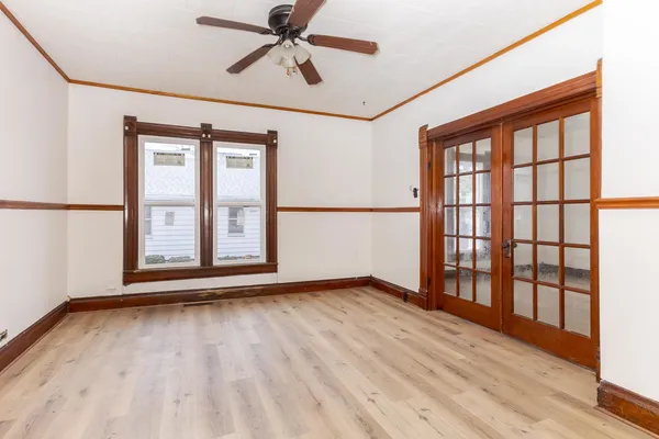 a view of a room with wooden floor and windows