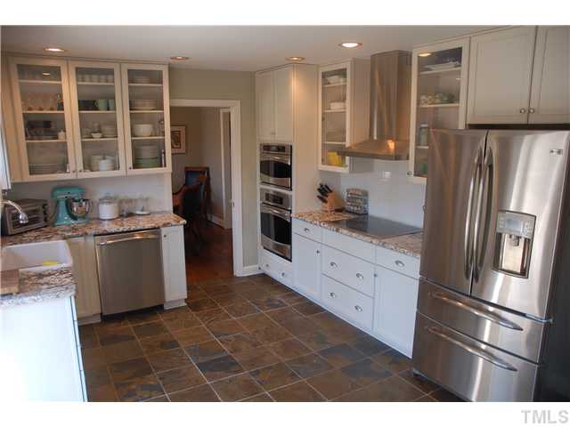 4409 Pitt Street Raleigh, NC 27609 - Photo 4 of 16 a kitchen with stainless steel appliances a refrigerator sink and cabinets