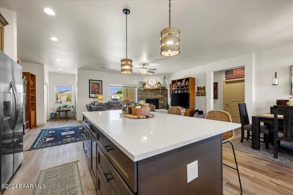 a view of kitchen island a sink and living room view