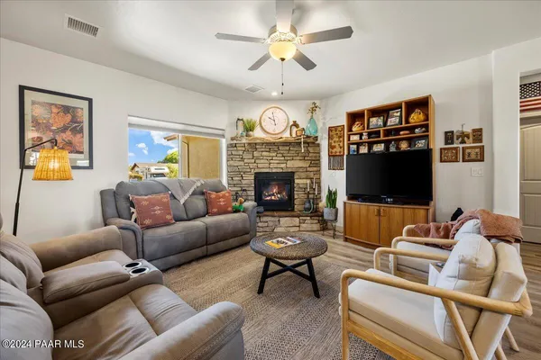 a living room with furniture a fireplace and a flat screen tv