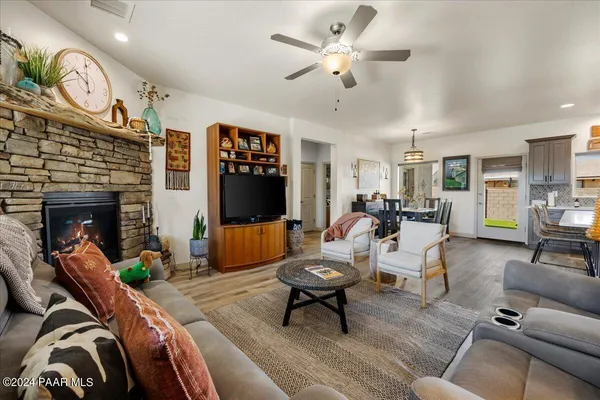 a living room with furniture a fireplace and a flat screen tv