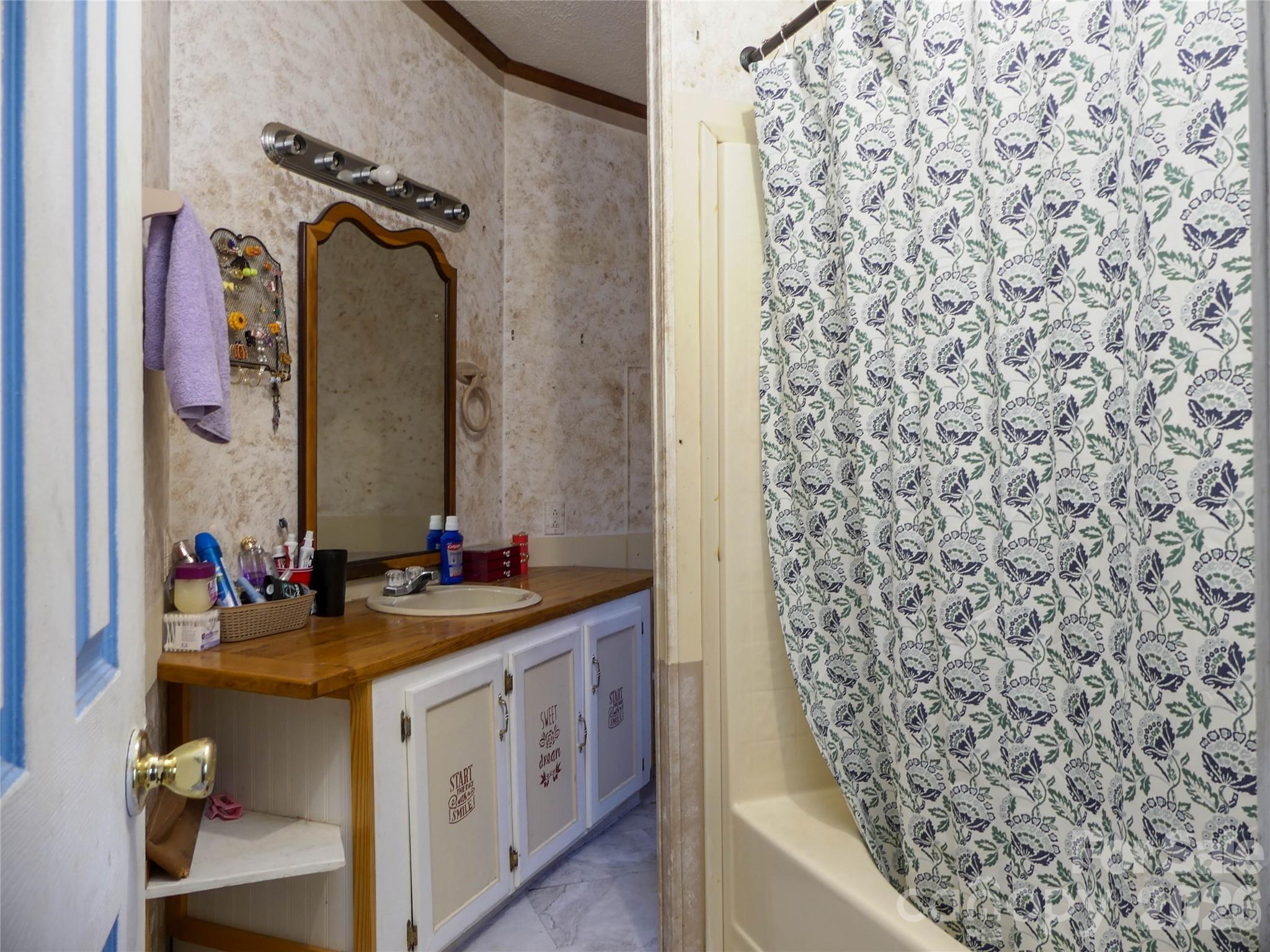 1490 Glenn Carlton Road Boomer, NC 28606 - Photo 11 of 14 a bathroom with a sink and a mirror