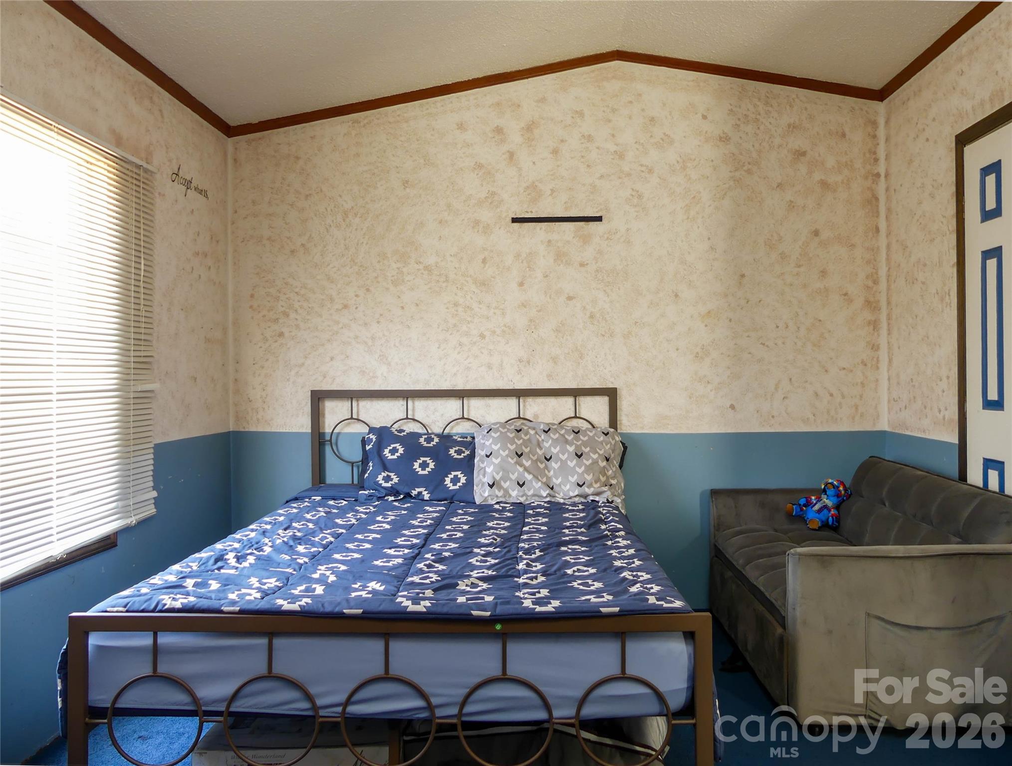 1490 Glenn Carlton Road Boomer, NC 28606 - Photo 4 of 14 a bed sitting in a bedroom next to a window with a flower pot