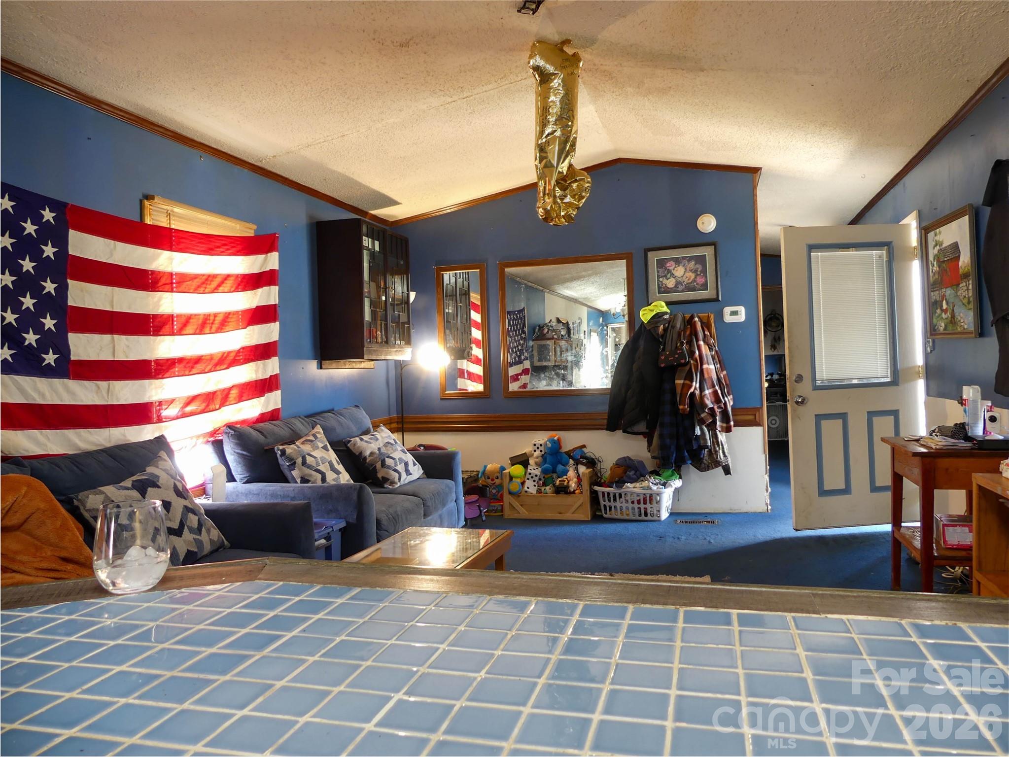 1490 Glenn Carlton Road Boomer, NC 28606 - Photo 8 of 14 a living room with furniture a flat screen tv and a floor to ceiling window