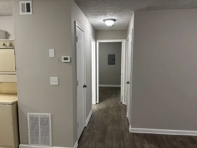 a view of a hallway with wooden floor