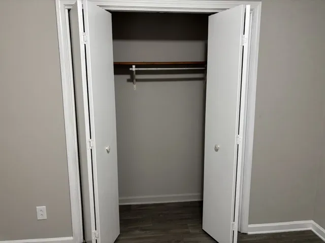 a view of walk in closet with empty racks