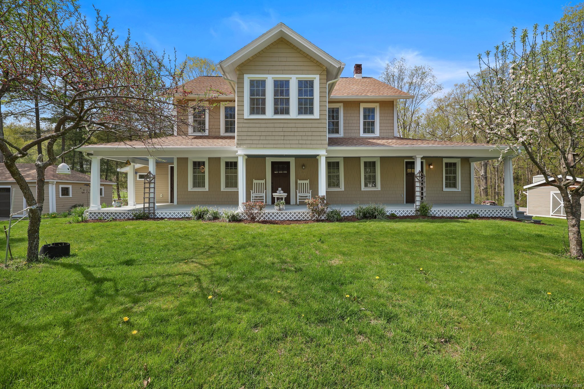 a front view of a house with a yard and potted plants