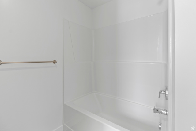 1262 West 500 South Logan, UT 84321 - Photo 32 of 39 White bathtub with integrated shower surround and chrome fixtures