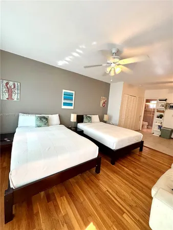 a bedroom with bed and wooden floor