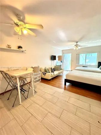 a bedroom with furniture and a view of living room