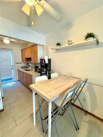 a kitchen with a table and chairs in it