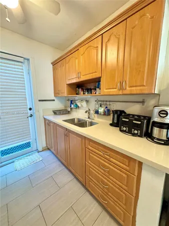 a kitchen with a sink a stove and cabinets