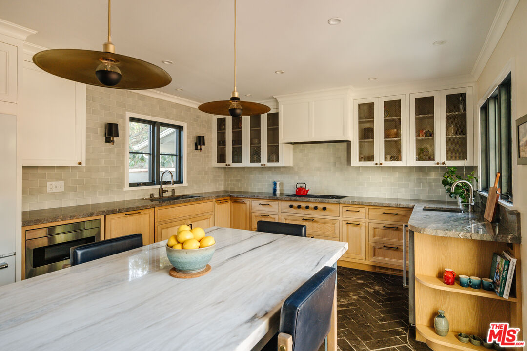1465 Royal Boulevard Glendale, CA 91207 - Photo 21 of 67 a kitchen with stainless steel appliances granite countertop a sink a stove and a wooden floors