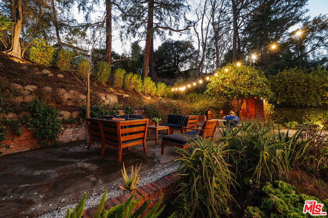 1465 Royal Boulevard Glendale, CA 91207 - Photo 61 of 67 a backyard of a house with table and chairs under an umbrella