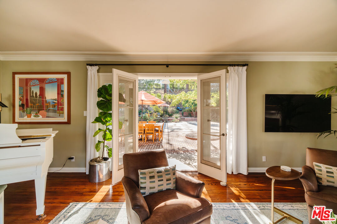 1465 Royal Boulevard Glendale, CA 91207 - Photo 10 of 67 a living room with furniture a flat screen tv and a floor to ceiling window