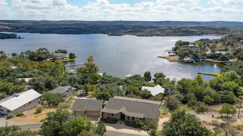 an aerial view of a house with a lake view