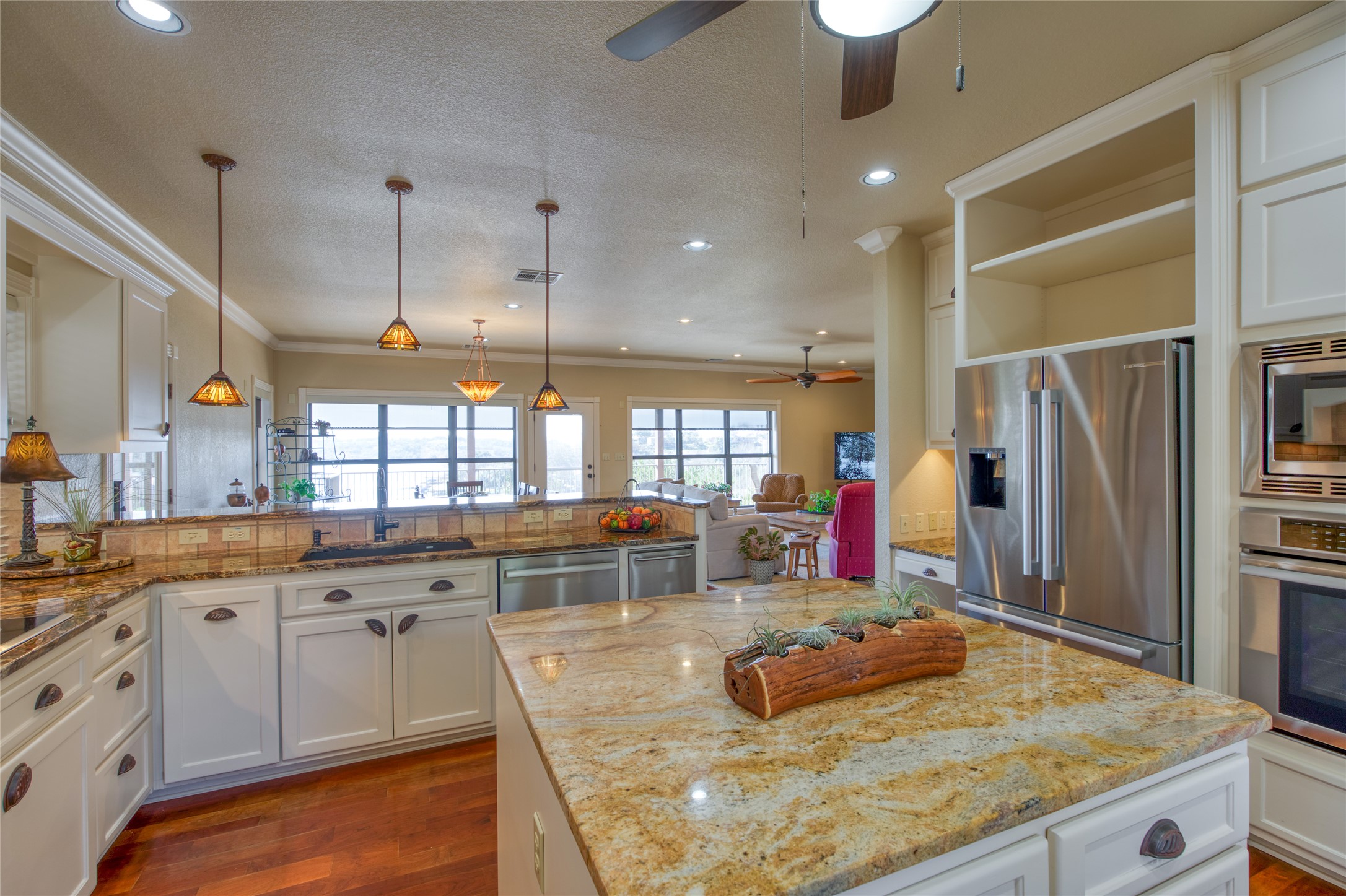 604 North Inwood Road Buchanan Dam, TX 78611 - Photo 11 of 35 a kitchen with stainless steel appliances granite countertop a sink and a refrigerator