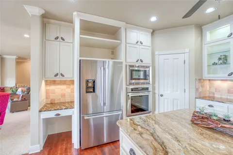 a bathroom with a granite countertop sink shower and a mirror