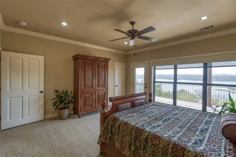 a spacious bedroom with a large bed and a chandelier