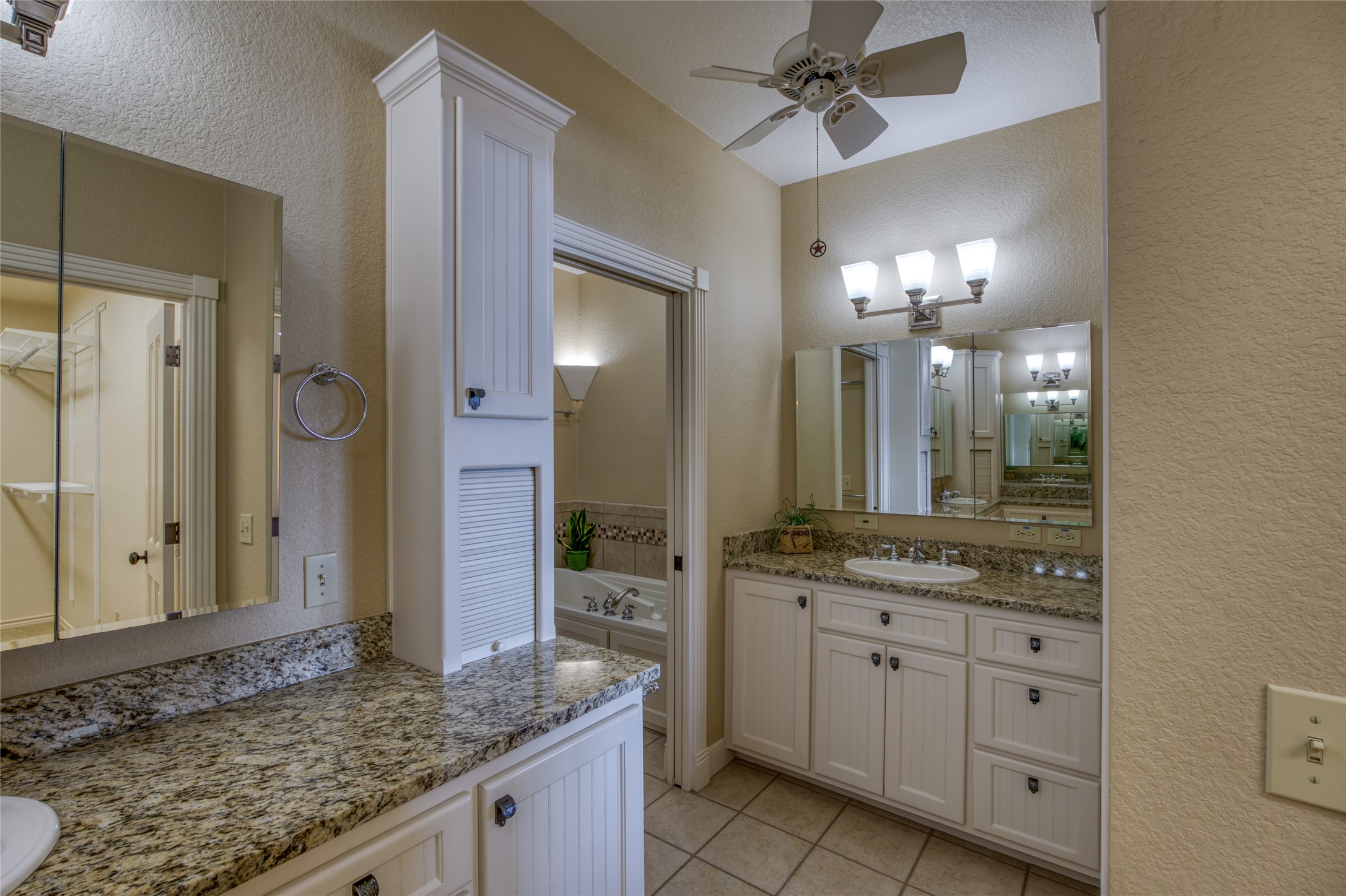 604 North Inwood Road Buchanan Dam, TX 78611 - Photo 17 of 35 a bathroom with a granite countertop sink and a mirror