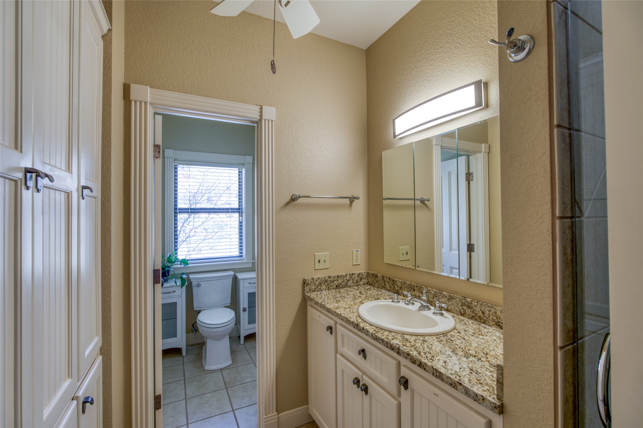 604 North Inwood Road Buchanan Dam, TX 78611 - Photo 21 of 35 a bathroom with a granite countertop sink and a mirror