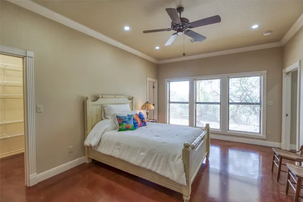 a bedroom with a bed and a large window