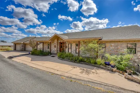a view of a hallway with wooden floor and stairs