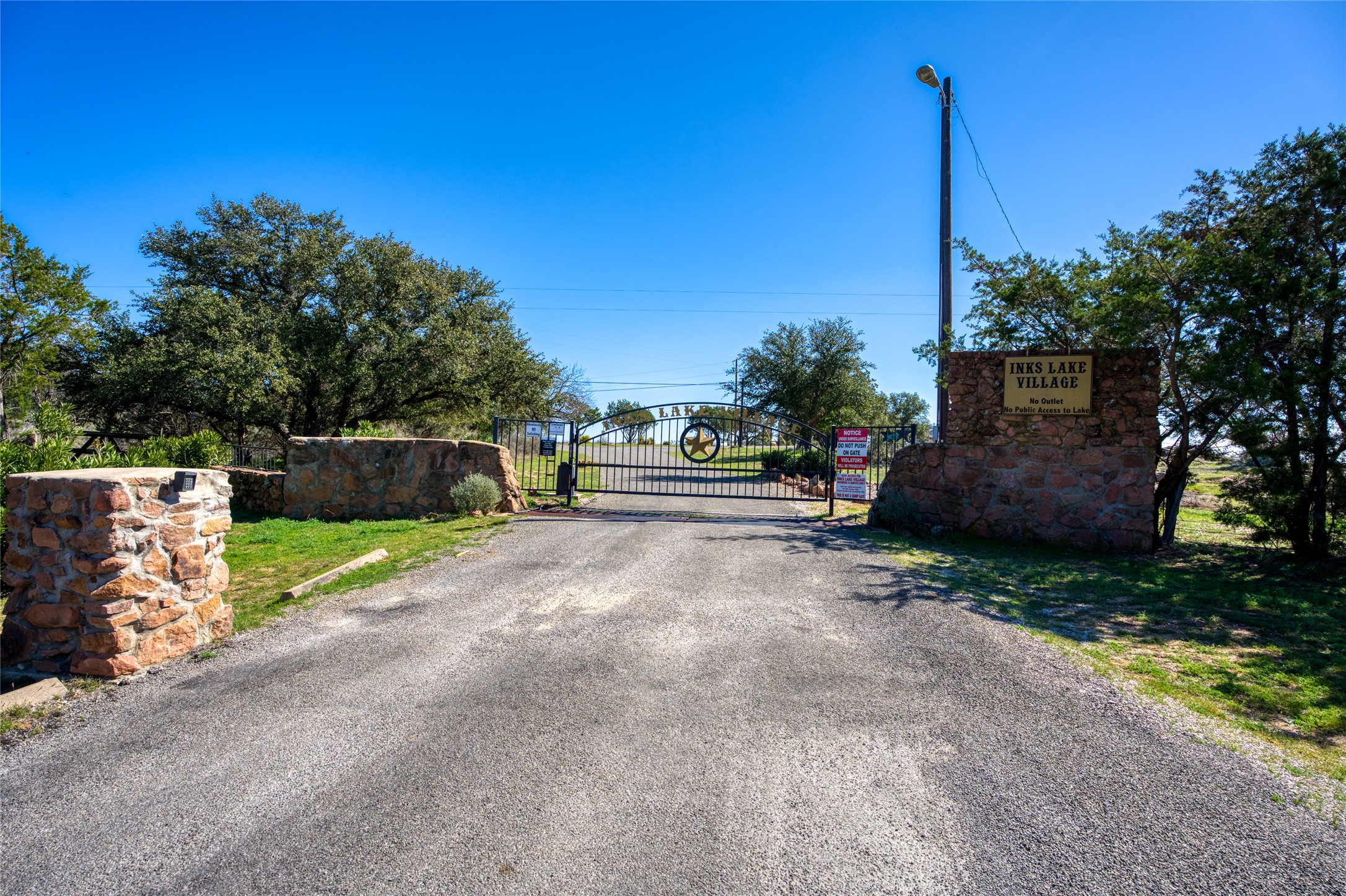 604 North Inwood Road Buchanan Dam, TX 78611 - Photo 35 of 35 a view of a street with potted plants and a large tree