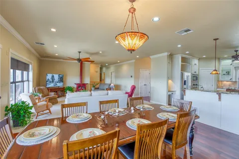 a view of a dining room with furniture a chandelier and wooden floor