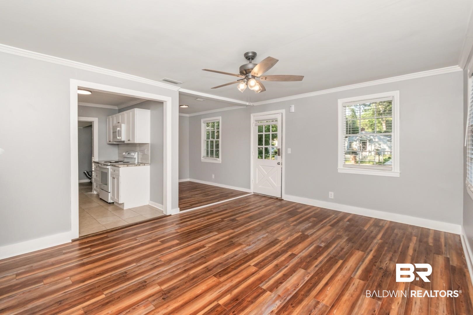 263 Border Drive East Mobile, AL 36608 - Photo 9 of 27 Spacious living area featuring wood-finish flooring, light gray walls, and white crown molding
