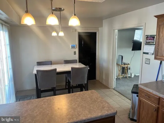 a dining room with furniture and a flat screen tv