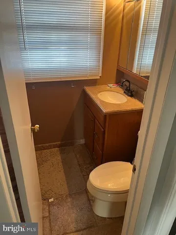 a white toilet sitting next to a sink