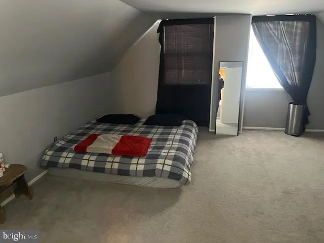 a bedroom with bed and a window